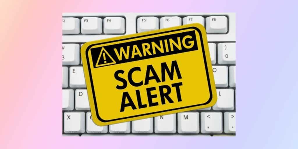 is seo a scam - white keyboard in the background and a warning label saying "scam alert"